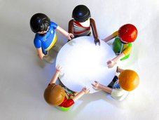 A group of toy people gathered around a table